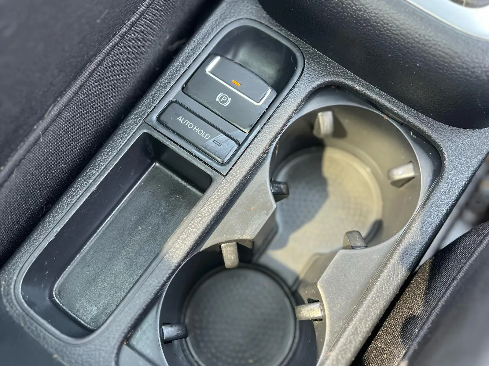 After — the same VW Tiguan center console and cupholders cleaned spotless by Wax N' Go