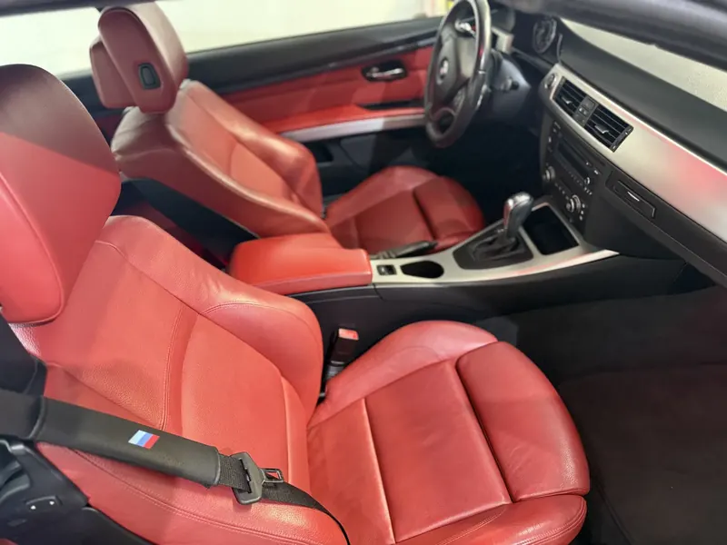 BMW M3 interior after a full interior detail — red leather seats conditioned and spotless