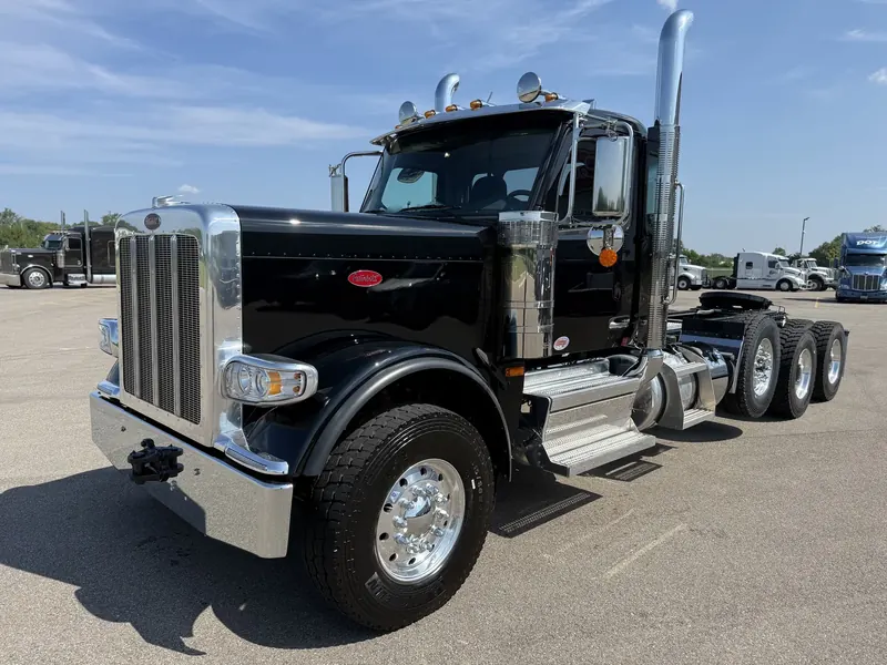 Black Peterbilt semi with chrome stacks after an exterior wash and detail