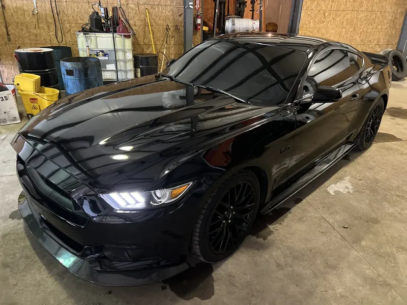 A sedan hand-washed and waxed to a clean shine by Wax N' Go