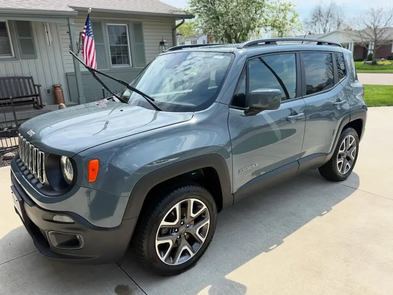 Grey Jeep Renegade exterior detail complete — paint clean and glossy in a driveway